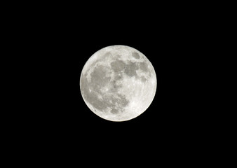 full moon very bright in the black winter sky