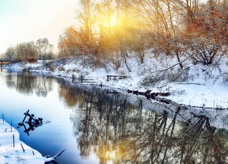 Foto auf Leinwand Winter landscape by a river in the sunset © pilat666
