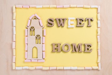 Fototapeta premium Word sweet home of marshmallow and abstract wooden letters.