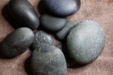 Fototapeta na wymiar Hot spa stones with bamboo on grey background, close-up