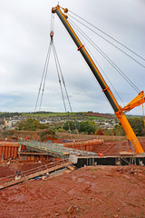 Crane lowering a bridge beam