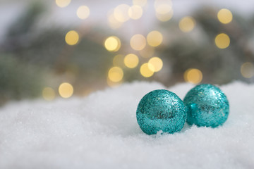 Weihnachtskugeln im Schnee mit Tannengrün
