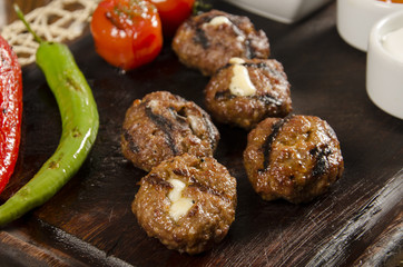 grilled meatballs with melted cheddar cheese