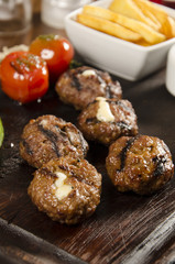 grilled meatballs with melted cheddar cheese