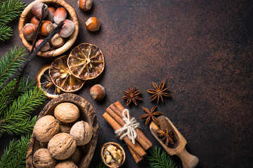 Christmas spices and  nuts on rusty stone table.