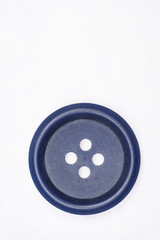 Sewing buttons on white background close up