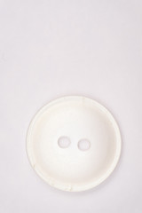 Sewing buttons on white background close up