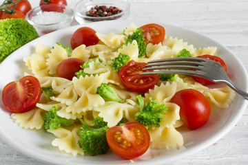 Pasta Salad with broccoli and tomato cherry with fork. vegetarian healthy food