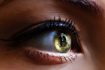 Close up view of beautiful female eye contact lenses Bitcoin eye of a person with the bitcoin coin...