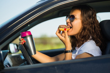 Driver eating tasty donut