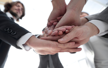 Obraz premium business people folding their hands together.