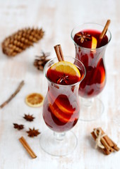 Two Glass of Hot Red Wine Wooden Background Cone Cinnamon Orange Winter Decor 