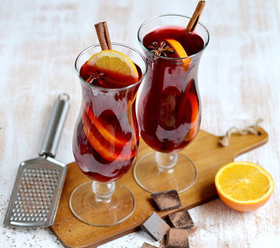 Two Glass of Hot Red Wine Wooden Background Cone Cinnamon Orange Winter Decor 