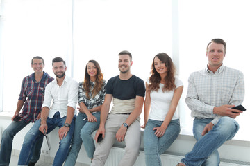 creative team sitting on the windowsill