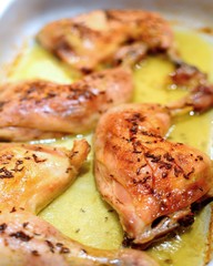 Close Up of a Roasted Chicken Drumsticks in a Roasting Pan.