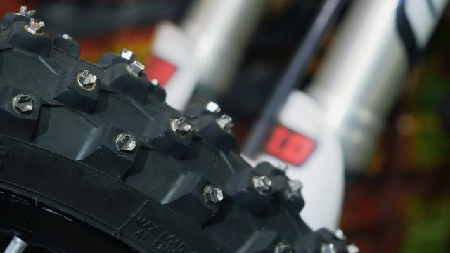 Woman use pink wrench and tries to screw a nut on wheel