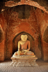 Sitting Buddha statue inside one of hundred old temples in Bagan, Myanmar