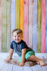 Fototapeta premium Portrait of happy and smiling child boy with blue eyes in her living room