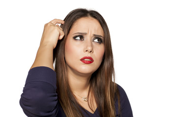 Portrait of confused young woman on white background