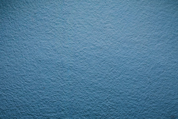 Design pattern background of blue paint closeup uneven wall.