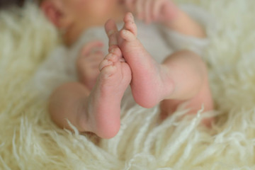 Newborn baby is sleeping in white clothes