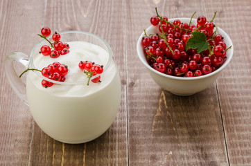 yogurt with red currant.on a wooden background/yogurt with red currant.on a wooden background. selective focus