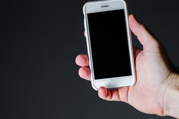 white smartphone in a woman's hand