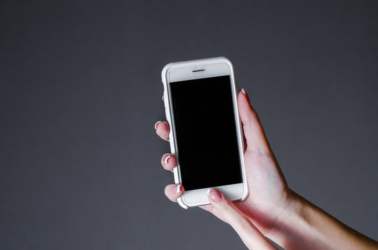 white smartphone in a woman's hand