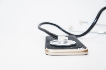 Broken phone, fixing the phone. Examination with a stethoscope. Taking care of the phone, phone updates, cleansing the smartphone. Returning a mobile phone to the site. Isolated white background.