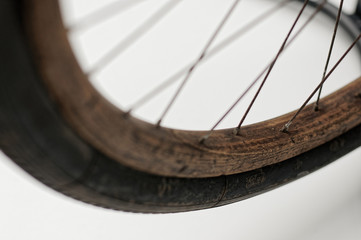 Old wooden bicycle wheel. - obrazy, fototapety, plakaty