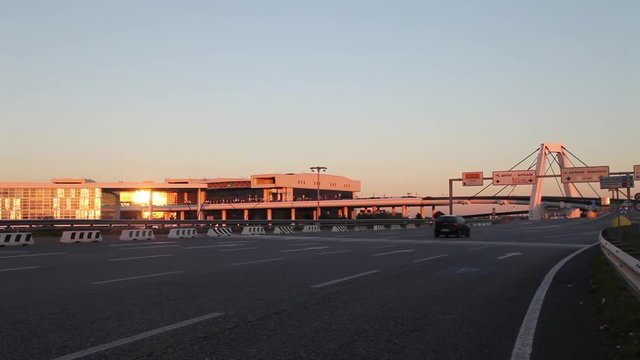 The highway to the international Airport of Milan Malpensa, full of traffic in sunset. This highway goes to terminal 1, to arrivals or departures for international flight or trips.