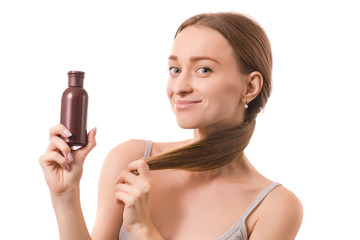 Beautiful young woman beauty face hair with bottle oil for hair