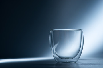 Empty glass on a blue background
