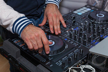 Fototapeta na wymiar The DJ's hands on the music console. DJ console cd mp4 deejay mixing desk music party in nightclub. DJ console for experiments with music