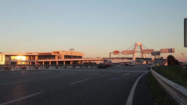 The highway to the international Airport of Milan Malpensa, full of traffic in sunset. This highway goes to terminal 1, to arrivals or departures for international flight or trips.
