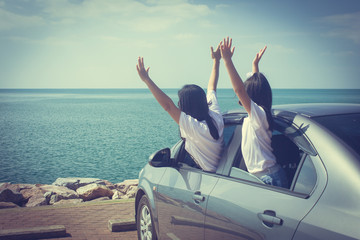 Vacation and Holiday Concept : Happy family car trip at the sea, Portrait woman and children feeling happiness in silver car.