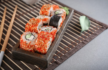 Tasty sushi rolls on table
