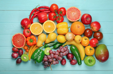Creative composition made of fruits and vegetables in rainbow colors on wooden background, flat lay