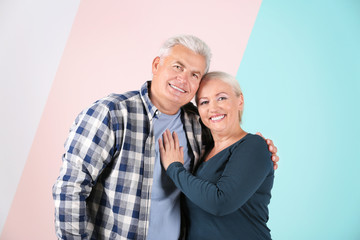 Mature couple against color background