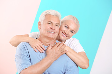 Mature couple against color background