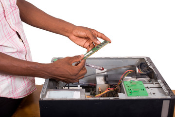 close up of technician hands repairing a computer isolated on wh