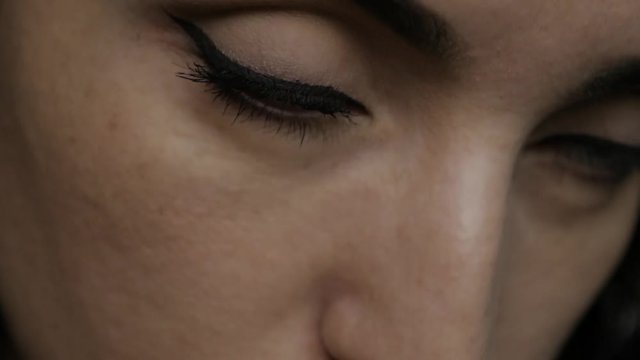 Make-up artist applying eyelash makeup to model's eye. Close up view. 4K