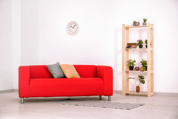 Living room interior with comfortable red sofa