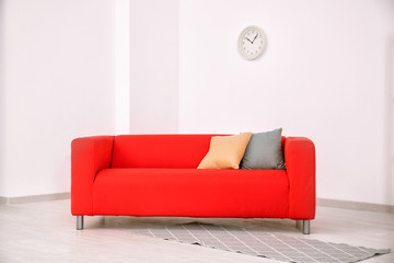 Comfortable red sofa in room