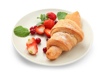 Plate with delicious croissant and berries on white background