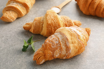 Tasty croissants on grey background