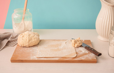 Raw puff pastry on wooden board