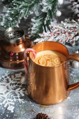 Holiday Eggnog cocktail served in copper mug on xmas background, selective focus