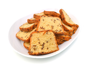 Sliced butter cake in plate on white background