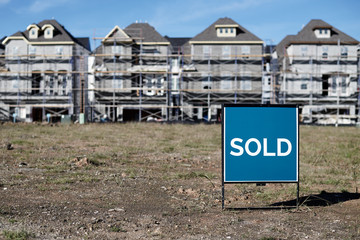 SOLD Sign Posted in Front of New Construction Houses in a Up-and-Coming Neighborhood